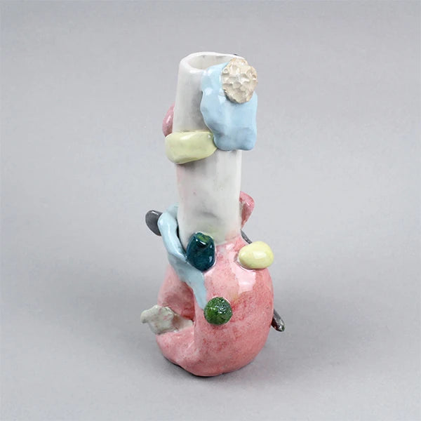 Hand-built decorative ceramic jar with organic, abstract forms and colourful details, made from earthenware and coloured earthenware, finished with a glossy transparent glaze. Created by artist Cíntia Coutinho, also known as Espirro, and photographed on a grey background.1621243260e1af0c20-1