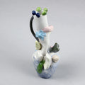 Hand-built decorative ceramic jar with organic, abstract forms and colourful details, made from earthenware and coloured earthenware, finished with a glossy transparent glaze. Created by artist Cíntia Coutinho, also known as Espirro, and photographed on a grey background.