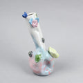 Hand-built decorative ceramic jar with organic, abstract forms and colourful details, made from earthenware and coloured earthenware, finished with a glossy transparent glaze. Created by artist Cíntia Coutinho, also known as Espirro, and photographed on a grey background.