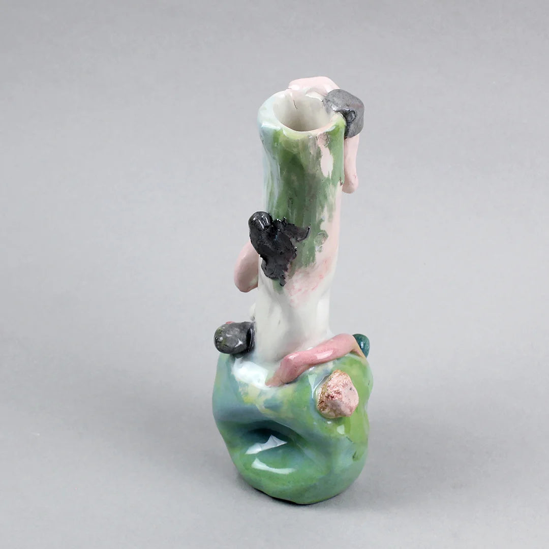 Hand-built decorative ceramic jar with organic, abstract forms and colourful details, made from earthenware and coloured earthenware, finished with a glossy transparent glaze. Created by artist Cíntia Coutinho, also known as Espirro, and photographed on a grey background.