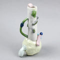 Hand-built decorative ceramic jar with organic, abstract forms and colourful details, made from earthenware and coloured earthenware, finished with a glossy transparent glaze. Created by artist Cíntia Coutinho, also known as Espirro, and photographed on a grey background.