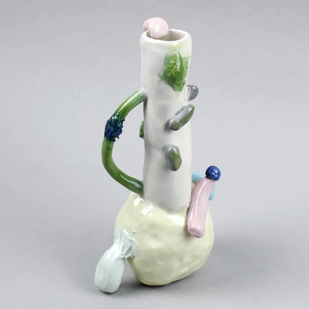 Hand-built decorative ceramic jar with organic, abstract forms and colourful details, made from earthenware and coloured earthenware, finished with a glossy transparent glaze. Created by artist Cíntia Coutinho, also known as Espirro, and photographed on a grey background.