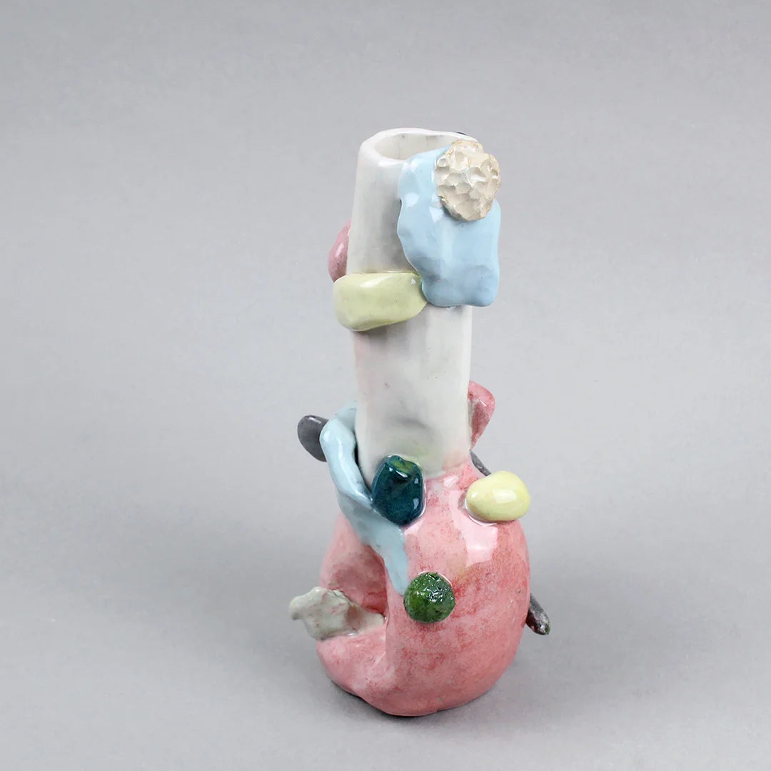 Hand-built decorative ceramic jar with organic, abstract forms and colourful details, made from earthenware and coloured earthenware, finished with a glossy transparent glaze. Created by artist Cíntia Coutinho, also known as Espirro, and photographed on a grey background.
