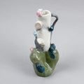 Hand-built decorative ceramic jar with organic, abstract forms and colourful details, made from earthenware and coloured earthenware, finished with a glossy transparent glaze. Created by artist Cíntia Coutinho, also known as Espirro, and photographed on a grey background.