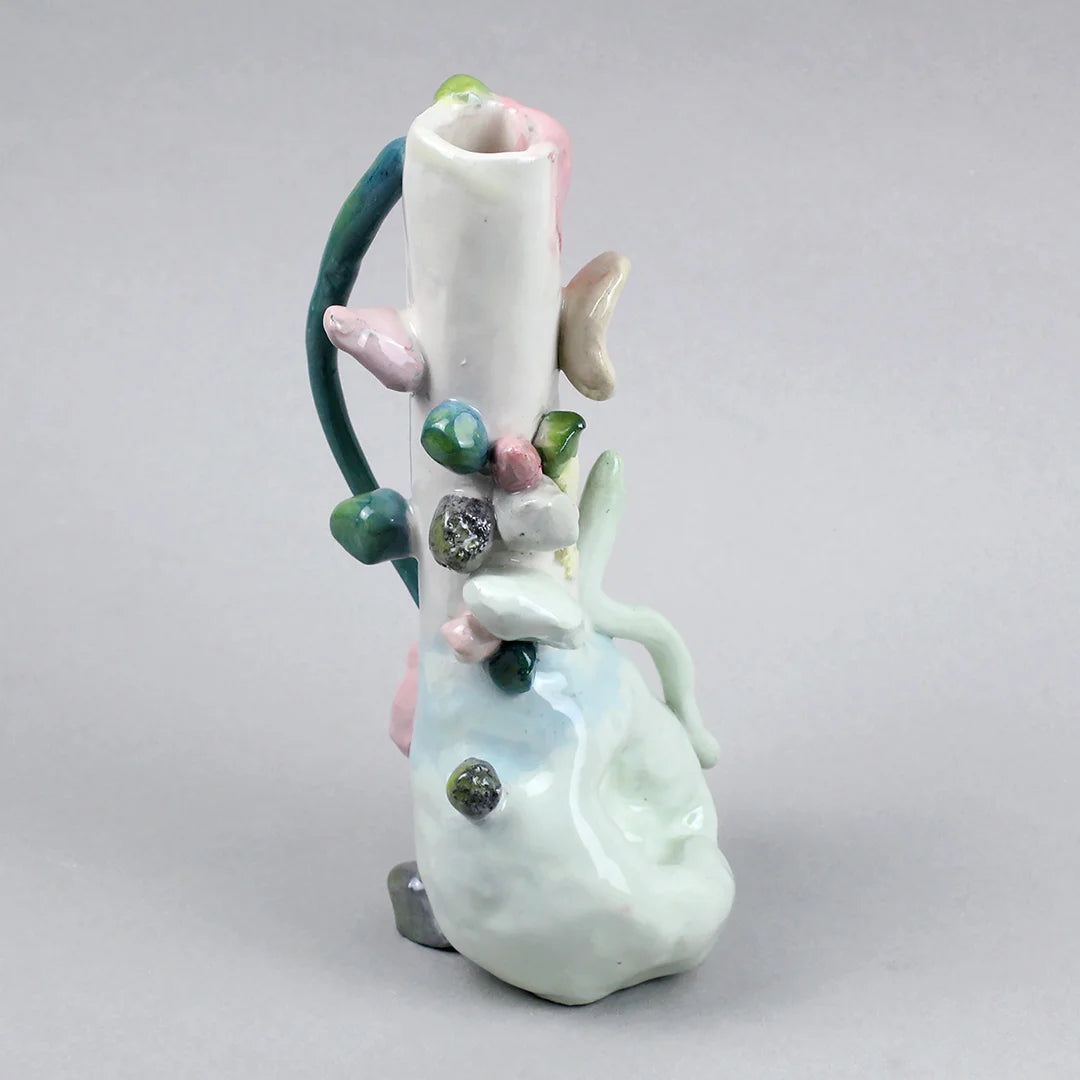 Hand-built decorative ceramic jar with organic, abstract forms and colourful details, made from earthenware and coloured earthenware, finished with a glossy transparent glaze. Created by artist Cíntia Coutinho, also known as Espirro, and photographed on a grey background.