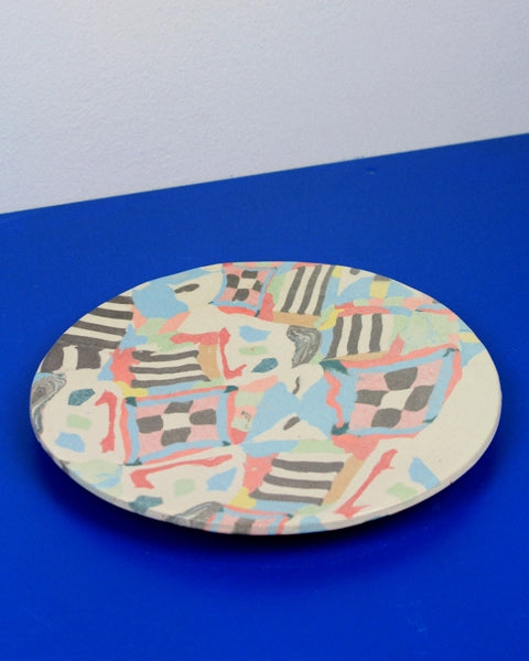 Hand-built decorative ceramic deep plate with organic, abstract forms and colourful details, made from earthenware and coloured earthenware, finished with a glossy transparent glaze. Created by artist Cíntia Coutinho, also known as Espirro.1621243260e1af0c20-1