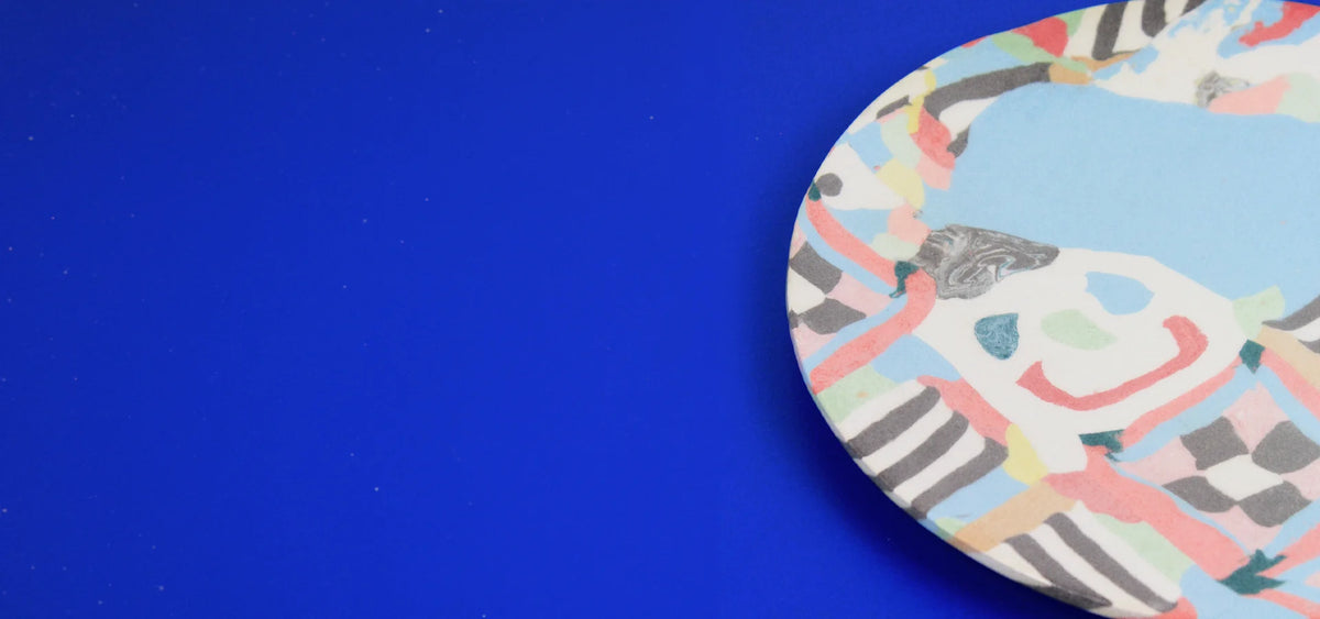 Hand-built decorative ceramic deep plate with organic, abstract forms and colourful details, made from earthenware and coloured earthenware, finished with a glossy transparent glaze. Created by artist Cíntia Coutinho, also known as Espirro.1621243260e1af0c20-1