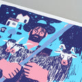 detail of a Screen print featuring an illustration by the artist Mantraste. At the centre of the print stands a large figure of a shepherd holding a staff, surrounded by animals such as sheep and goats. The artwork is rendered in light blue, pink, and dark blue tones, set against a grey background.