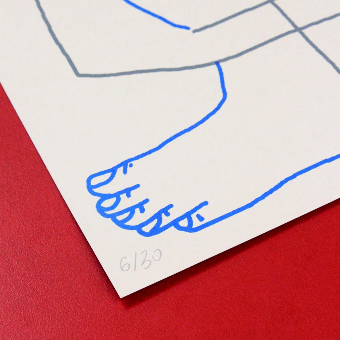 detail of a Manual screen print (50×70 cm) of an illustration of Tina Siuda showing two bodies embracing, drawn with fine linework on a white background. The figures extend almost to the edges of the paper, as if confined within its borders. The print is framed in a grey frame and hung on a Klein blue wall with matching blue metal bars.