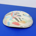 Hand-built decorative ceramic plate with organic, abstract forms and colourful details, made from earthenware and coloured earthenware, finished with a glossy transparent glaze. Created by artist Cíntia Coutinho, also known as Espirro.