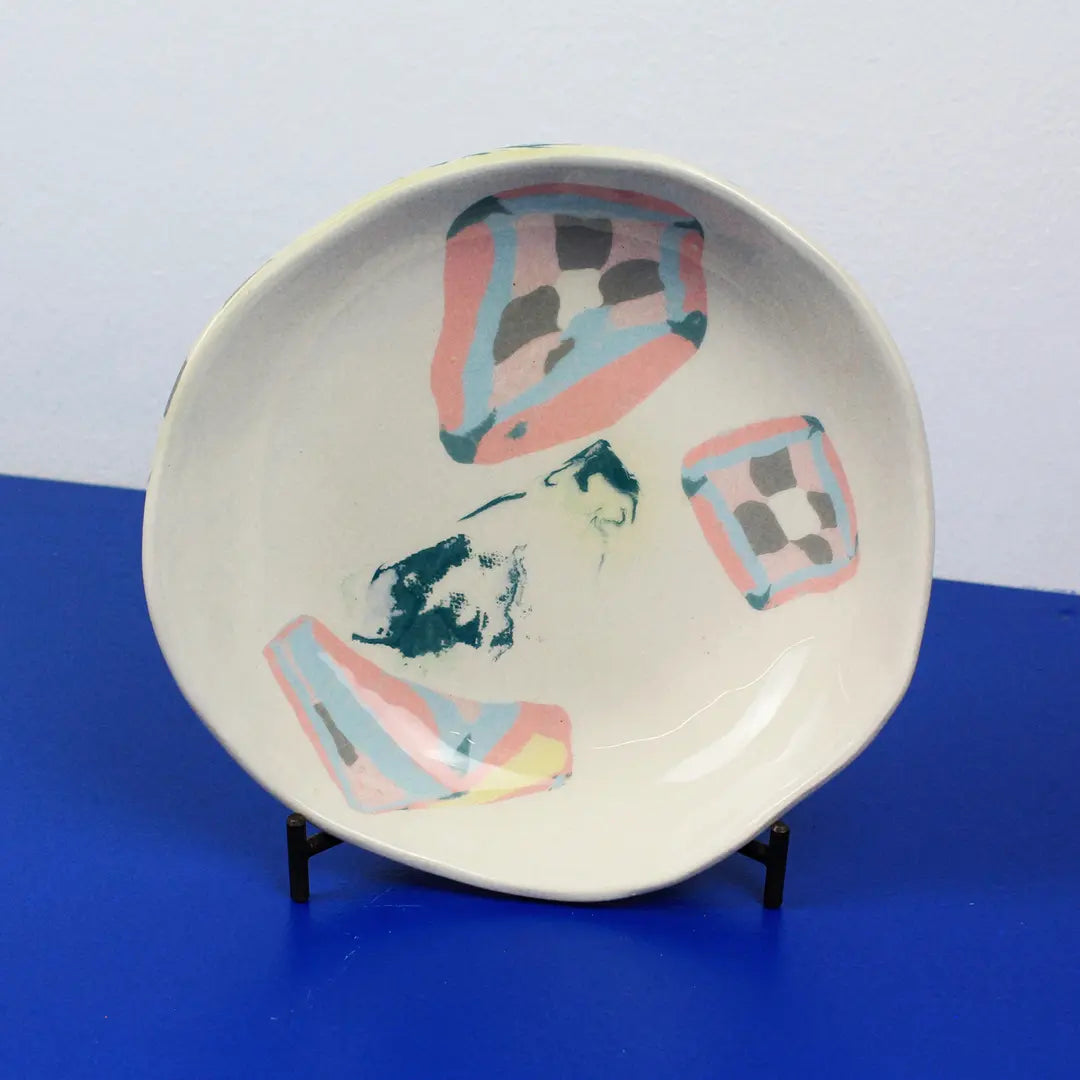 Hand-built decorative ceramic deep plate with organic, abstract forms and colourful details, made from earthenware and coloured earthenware, finished with a glossy transparent glaze. Created by artist Cíntia Coutinho, also known as Espirro.