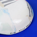 Hand-built decorative ceramic deep plate with organic, abstract forms and colourful details, made from earthenware and coloured earthenware, finished with a glossy transparent glaze. Created by artist Cíntia Coutinho, also known as Espirro.