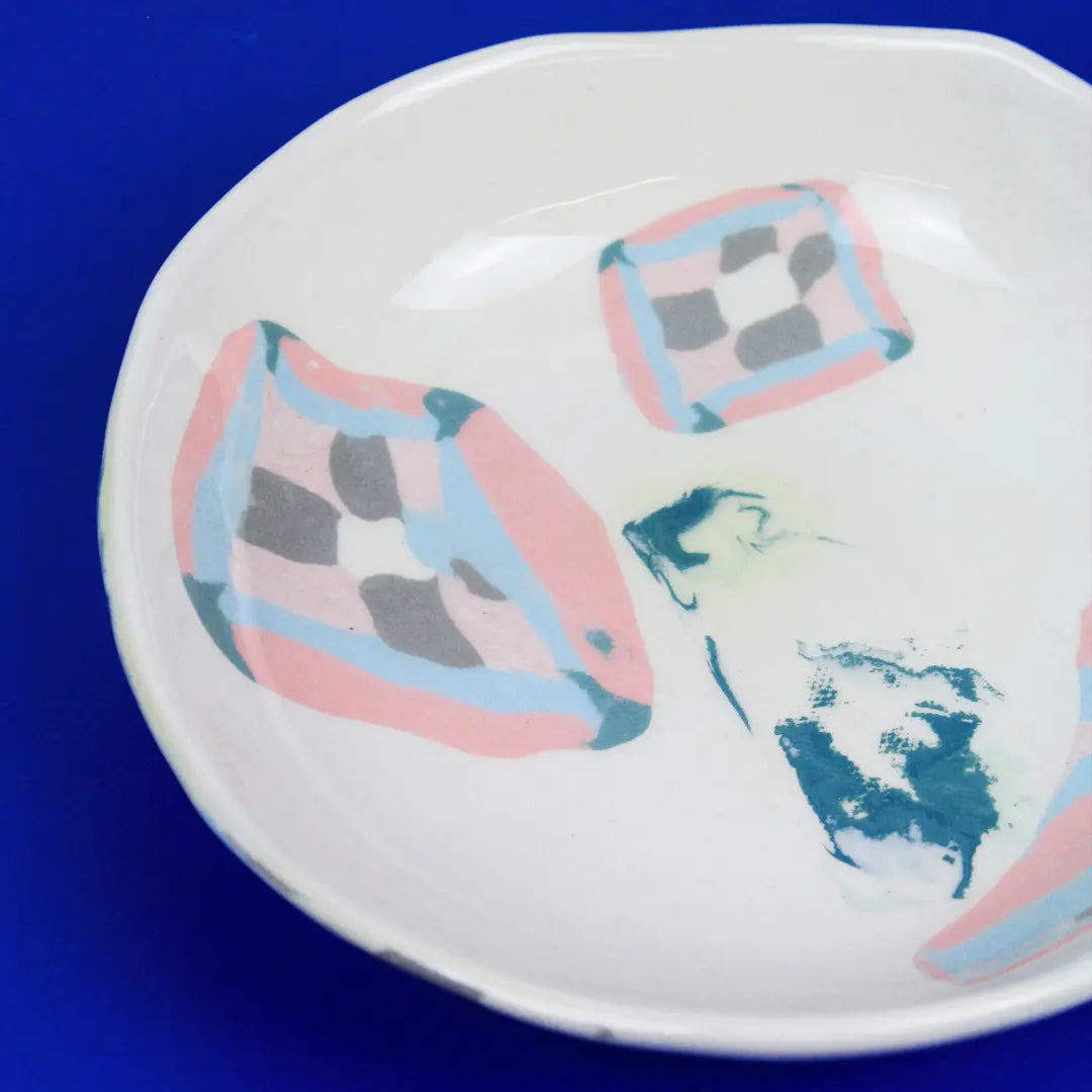 Hand-built decorative ceramic deep plate with organic, abstract forms and colourful details, made from earthenware and coloured earthenware, finished with a glossy transparent glaze. Created by artist Cíntia Coutinho, also known as Espirro.