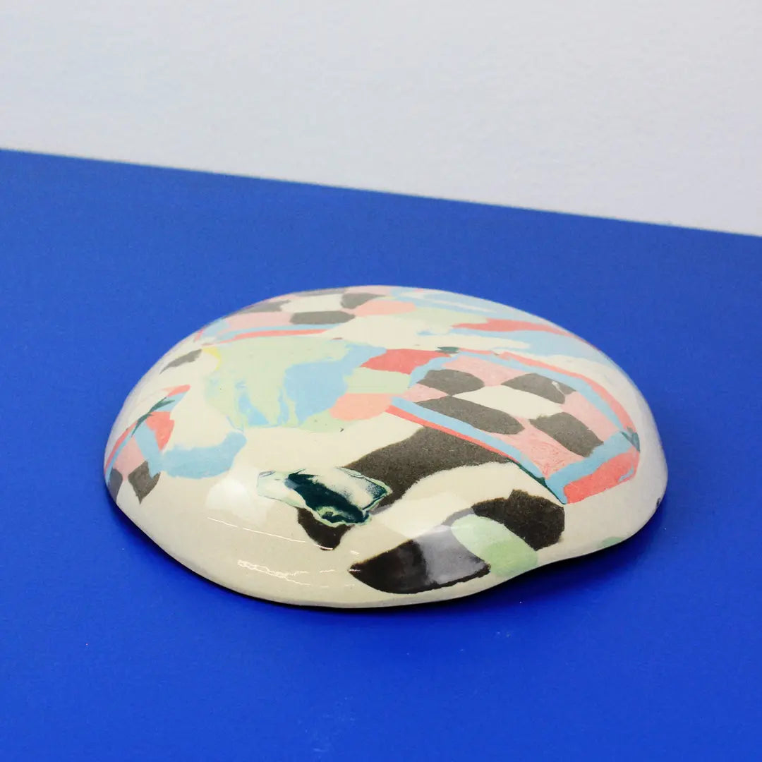Hand-built decorative ceramic deep plate with organic, abstract forms and colourful details, made from earthenware and coloured earthenware, finished with a glossy transparent glaze. Created by artist Cíntia Coutinho, also known as Espirro.