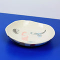 Hand-built decorative ceramic deep plate with organic, abstract forms and colourful details, made from earthenware and coloured earthenware, finished with a glossy transparent glaze. Created by artist Cíntia Coutinho, also known as Espirro.