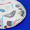 Hand-built decorative ceramic deep plate with organic, abstract forms and colourful details, made from earthenware and coloured earthenware, finished with a glossy transparent glaze. Created by artist Cíntia Coutinho, also known as Espirro.