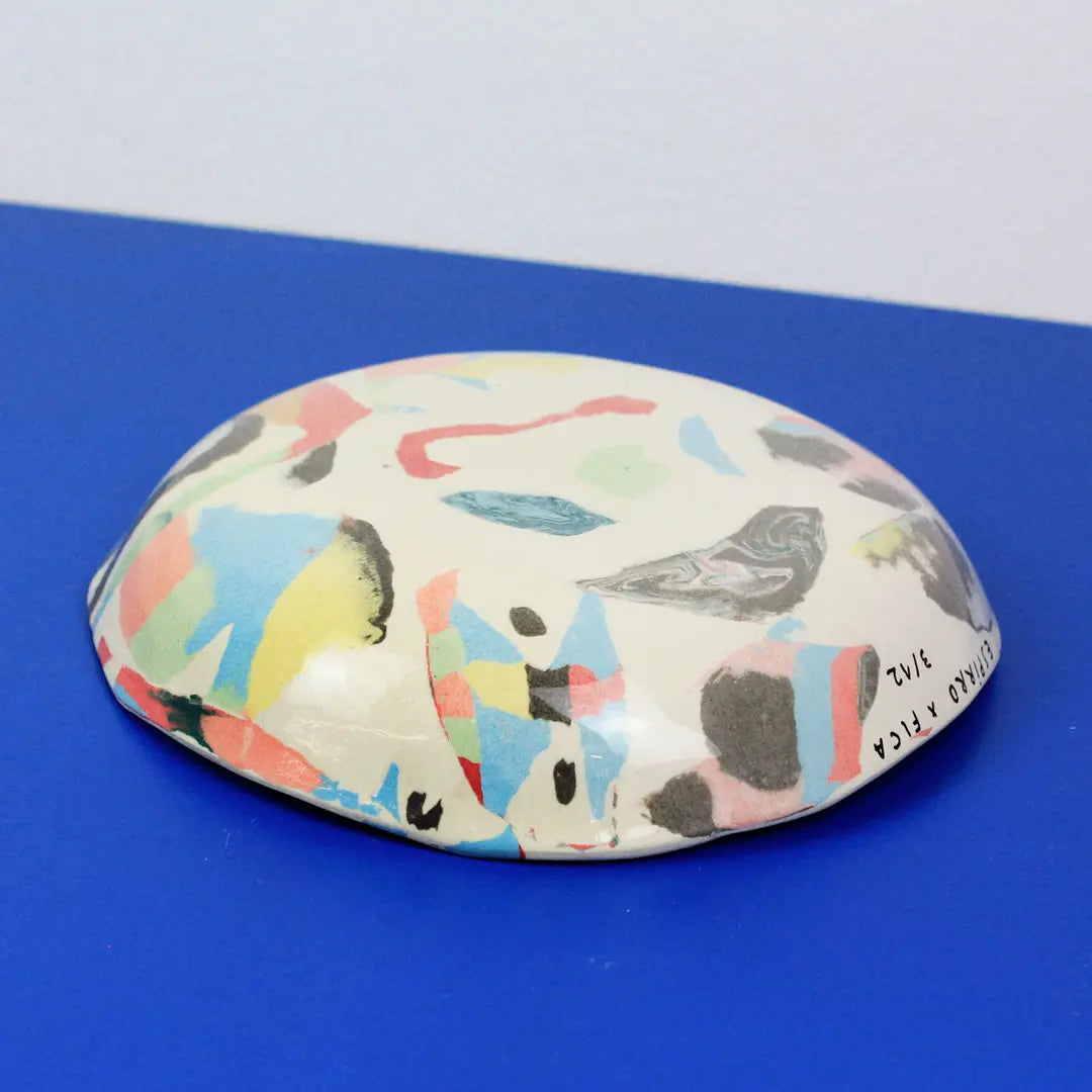 Hand-built decorative ceramic deep plate with organic, abstract forms and colourful details, made from earthenware and coloured earthenware, finished with a glossy transparent glaze. Created by artist Cíntia Coutinho, also known as Espirro.