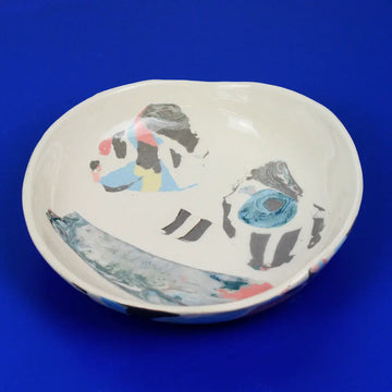 Hand-built decorative ceramic deep plate with organic, abstract forms and colourful details, made from earthenware and coloured earthenware, finished with a glossy transparent glaze. Created by artist Cíntia Coutinho, also known as Espirro.