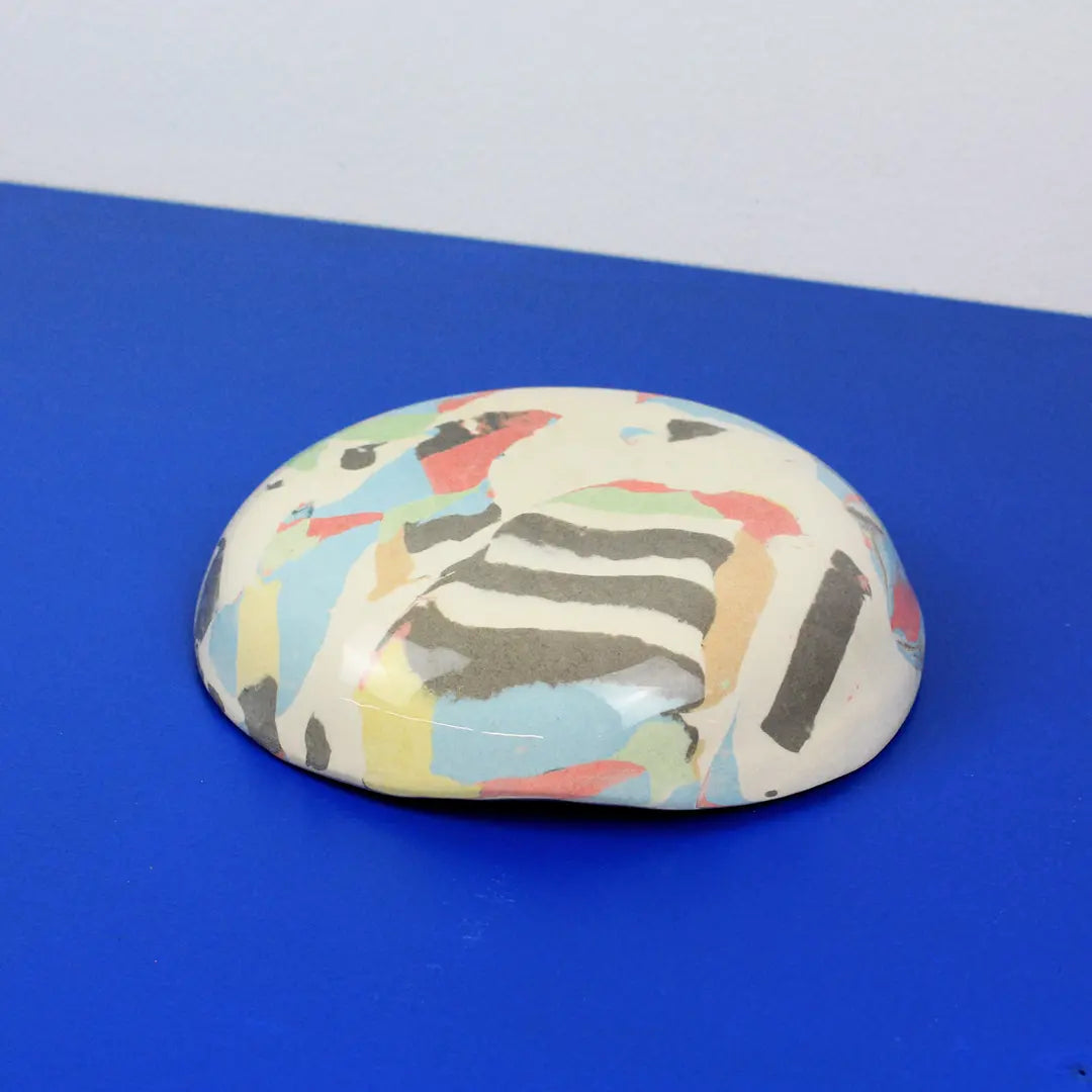Hand-built decorative ceramic deep plate with organic, abstract forms and colourful details, made from earthenware and coloured earthenware, finished with a glossy transparent glaze. Created by artist Cíntia Coutinho, also known as Espirro.