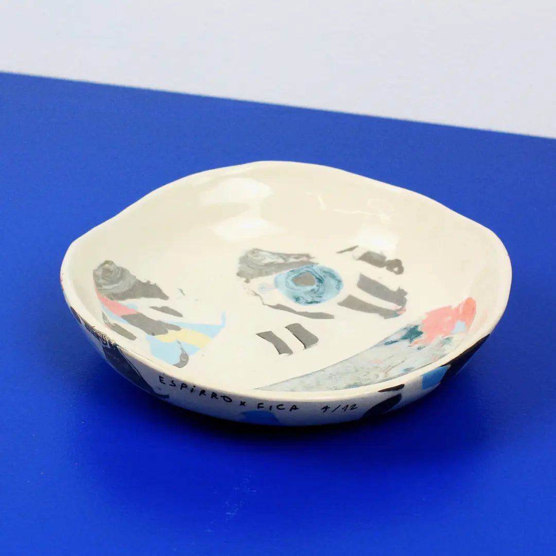 Hand-built decorative ceramic deep plate with organic, abstract forms and colourful details, made from earthenware and coloured earthenware, finished with a glossy transparent glaze. Created by artist Cíntia Coutinho, also known as Espirro.