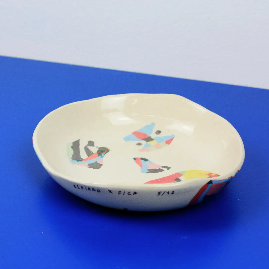 Hand-built decorative ceramic deep plate with organic, abstract forms and colourful details, made from earthenware and coloured earthenware, finished with a glossy transparent glaze. Created by artist Cíntia Coutinho, also known as Espirro.