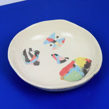 Hand-built decorative ceramic deep plate with organic, abstract forms and colourful details, made from earthenware and coloured earthenware, finished with a glossy transparent glaze. Created by artist Cíntia Coutinho, also known as Espirro.