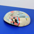 Hand-built decorative ceramic deep plate with organic, abstract forms and colourful details, made from earthenware and coloured earthenware, finished with a glossy transparent glaze. Created by artist Cíntia Coutinho, also known as Espirro.