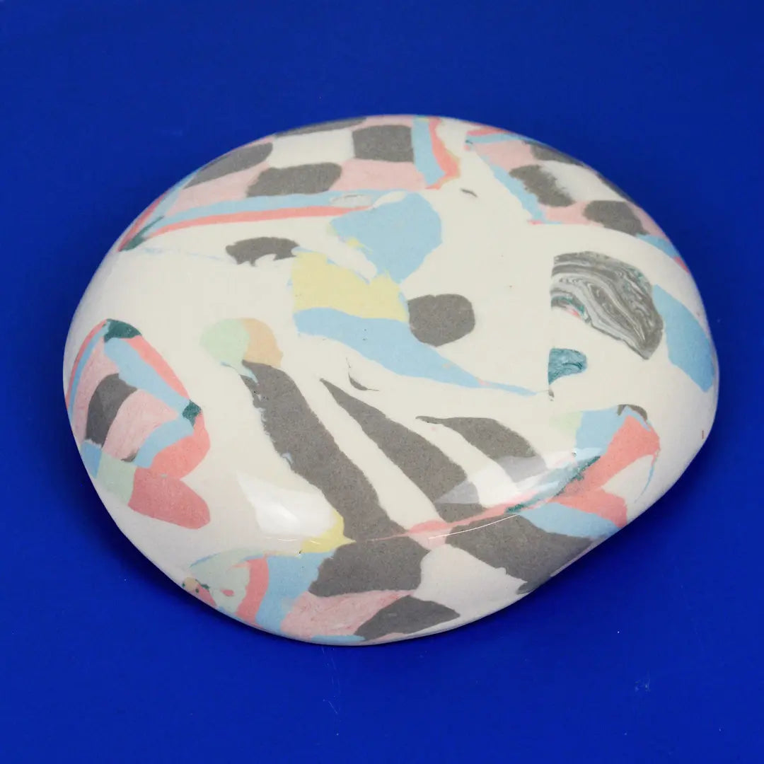 Hand-built decorative ceramic deep plate with organic, abstract forms and colourful details, made from earthenware and coloured earthenware, finished with a glossy transparent glaze. Created by artist Cíntia Coutinho, also known as Espirro.