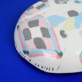 Hand-built decorative ceramic deep plate with organic, abstract forms and colourful details, made from earthenware and coloured earthenware, finished with a glossy transparent glaze. Created by artist Cíntia Coutinho, also known as Espirro.
