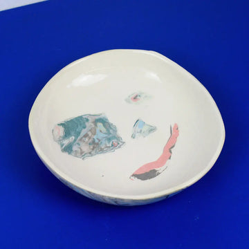 Hand-built decorative ceramic deep plate with organic, abstract forms and colourful details, made from earthenware and coloured earthenware, finished with a glossy transparent glaze. Created by artist Cíntia Coutinho, also known as Espirro.