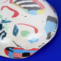 Hand-built decorative ceramic deep plate with organic, abstract forms and colourful details, made from earthenware and coloured earthenware, finished with a glossy transparent glaze. Created by artist Cíntia Coutinho, also known as Espirro.