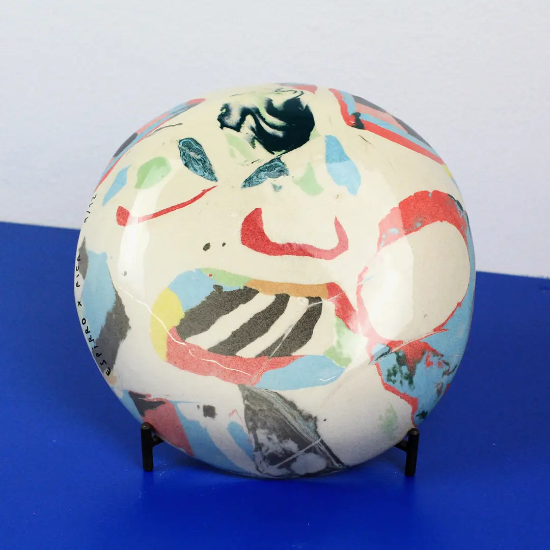 Hand-built decorative ceramic deep plate with organic, abstract forms and colourful details, made from earthenware and coloured earthenware, finished with a glossy transparent glaze. Created by artist Cíntia Coutinho, also known as Espirro.
