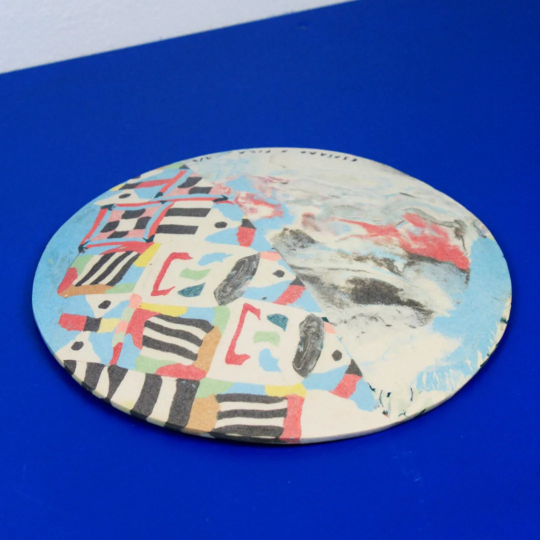 Hand-built decorative ceramic flat plate with organic, abstract forms and colourful details, made from earthenware and coloured earthenware, finished with a glossy transparent glaze. Created by artist Cíntia Coutinho, also known as Espirro.