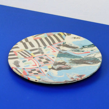 Hand-built decorative ceramic plate with organic, abstract forms and colourful details, made from earthenware and coloured earthenware, finished with a glossy transparent glaze. Created by artist Cíntia Coutinho, also known as Espirro.