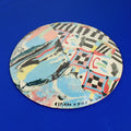 Hand-built decorative ceramic plate with organic, abstract forms and colourful details, made from earthenware and coloured earthenware, finished with a glossy transparent glaze. Created by artist Cíntia Coutinho, also known as Espirro.