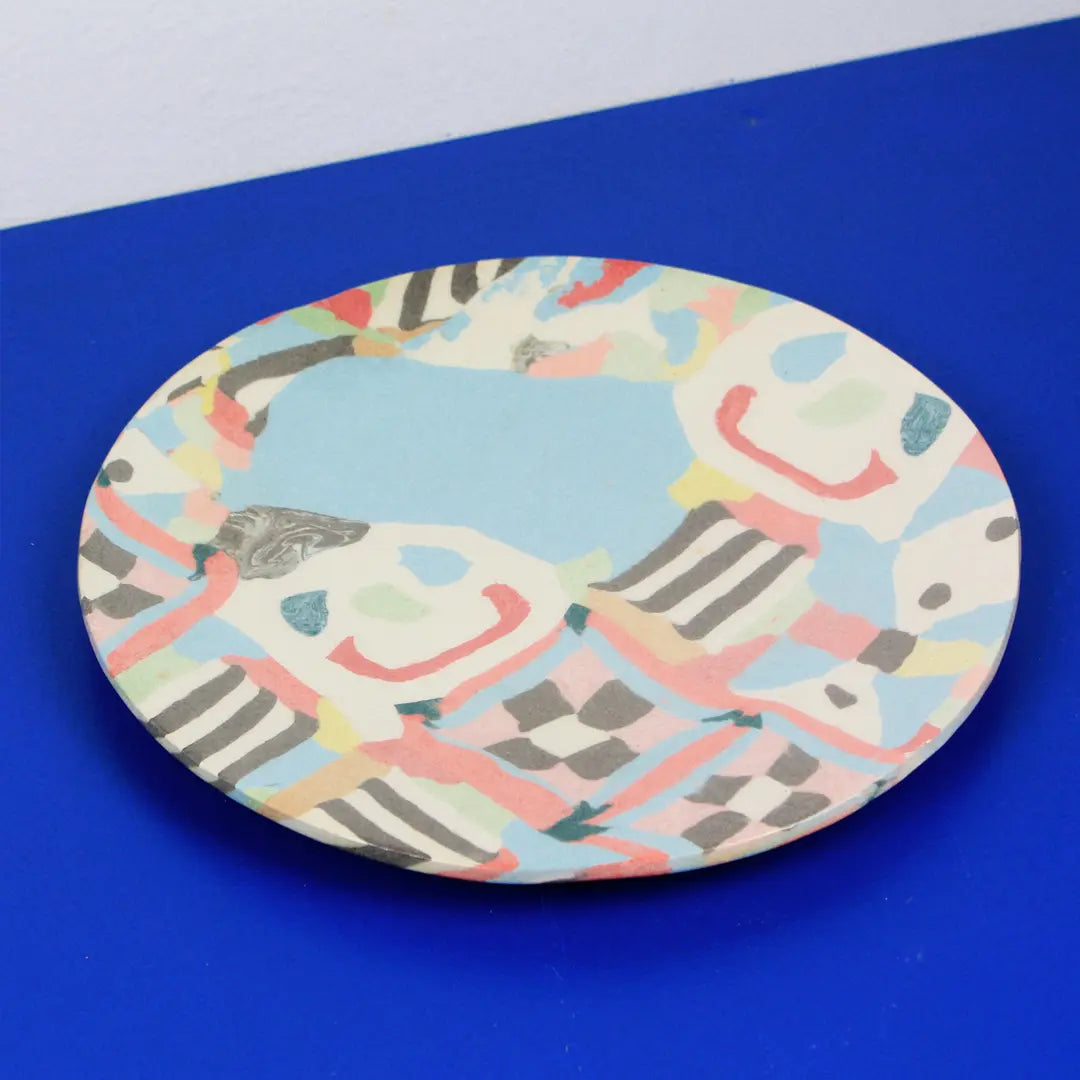 Hand-built decorative ceramic plate with organic, abstract forms and colourful details, made from earthenware and coloured earthenware, finished with a glossy transparent glaze. Created by artist Cíntia Coutinho, also known as Espirro.
