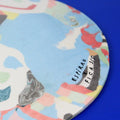 Hand-built decorative ceramic plate with organic, abstract forms and colourful details, made from earthenware and coloured earthenware, finished with a glossy transparent glaze. Created by artist Cíntia Coutinho, also known as Espirro.