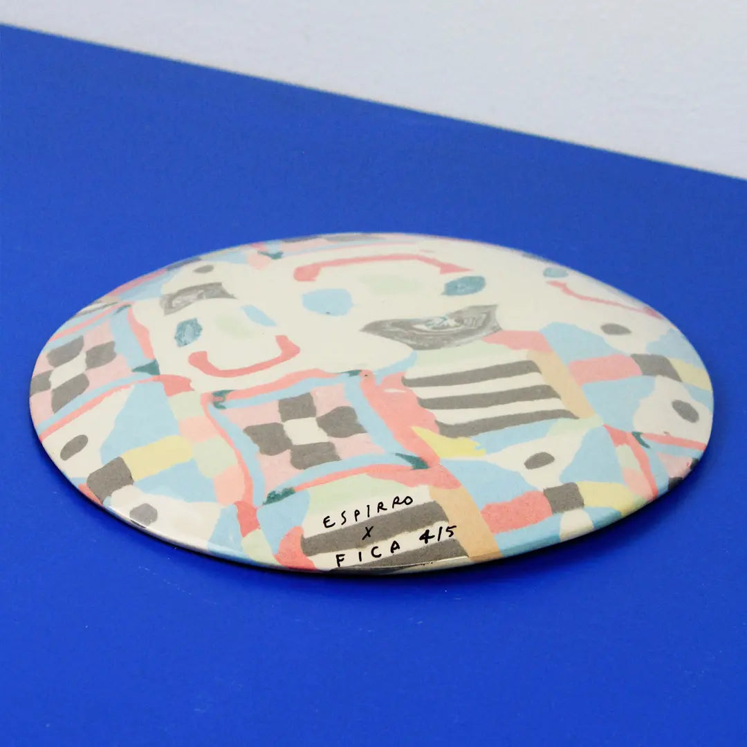 Hand-built decorative ceramic plate with organic, abstract forms and colourful details, made from earthenware and coloured earthenware, finished with a glossy transparent glaze. Created by artist Cíntia Coutinho, also known as Espirro.