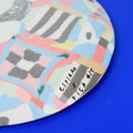 Hand-built decorative ceramic plate with organic, abstract forms and colourful details, made from earthenware and coloured earthenware, finished with a glossy transparent glaze. Created by artist Cíntia Coutinho, also known as Espirro.