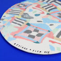 Hand-built decorative ceramic plate with organic, abstract forms and colourful details, made from earthenware and coloured earthenware, finished with a glossy transparent glaze. Created by artist Cíntia Coutinho, also known as Espirro.