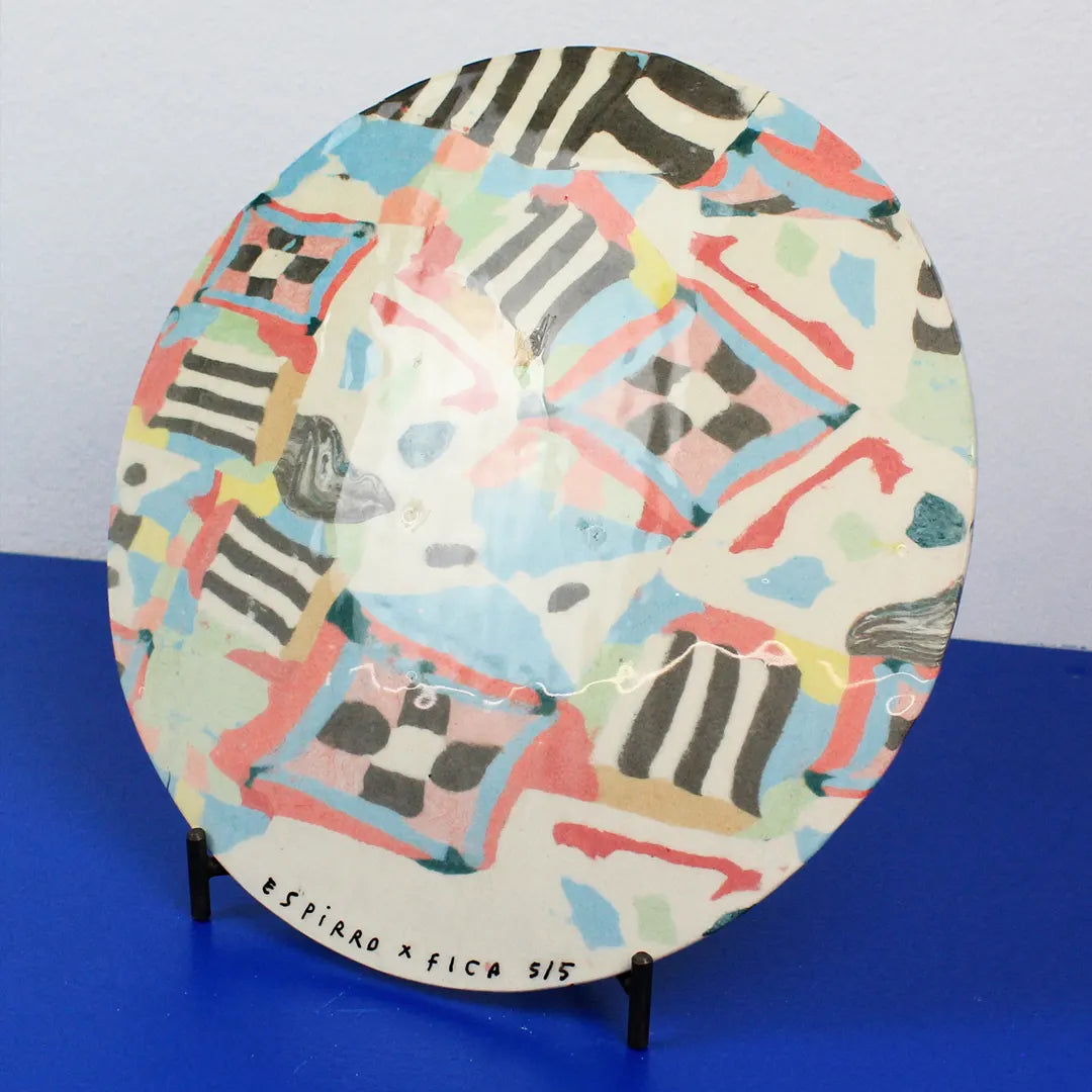 Hand-built decorative ceramic plate with organic, abstract forms and colourful details, made from earthenware and coloured earthenware, finished with a glossy transparent glaze. Created by artist Cíntia Coutinho, also known as Espirro.