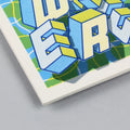 Detail of a Screen-printed tile with an Artwork from Halfstudio, with blue, yellow and green colors, against a gray background