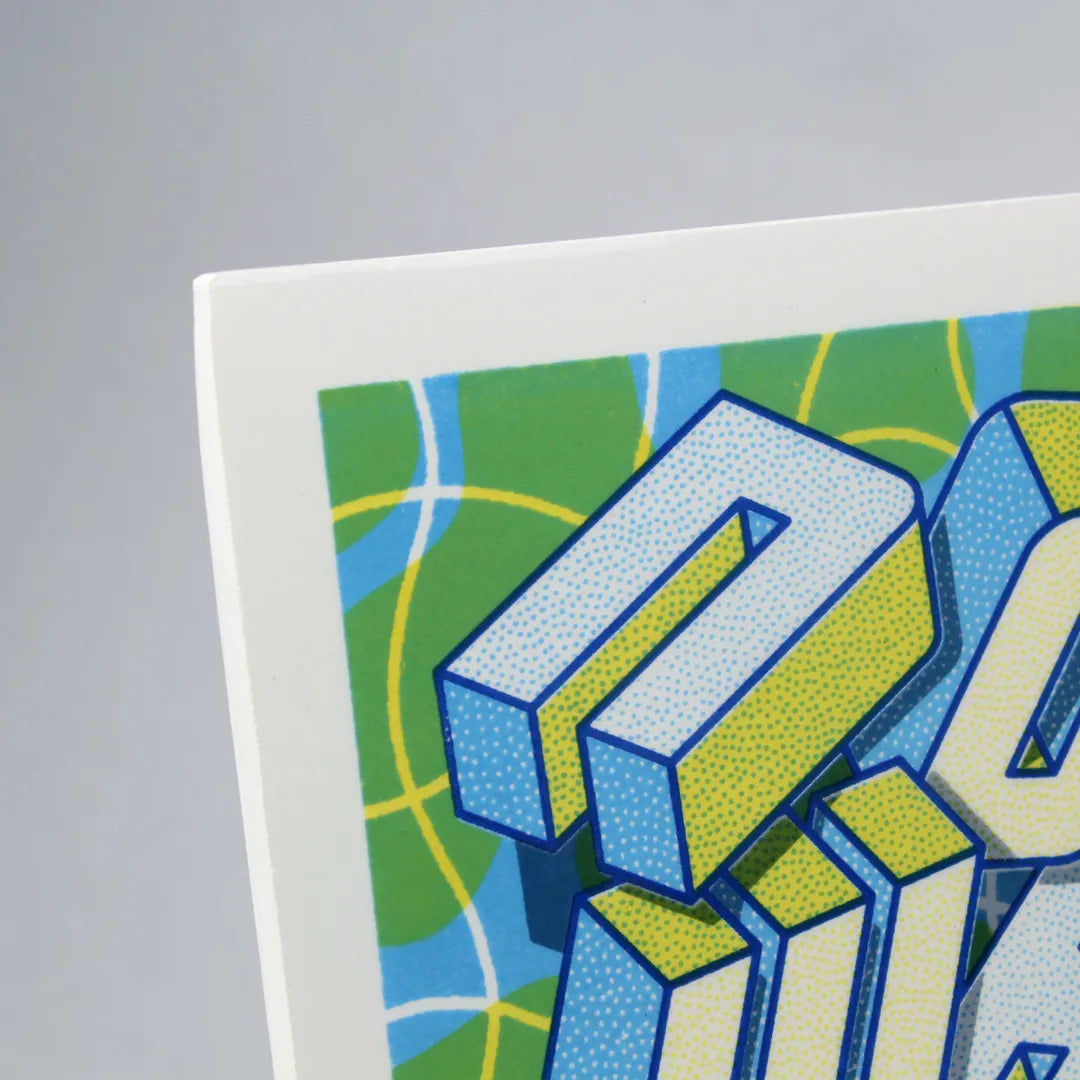 Detail of a Screen-printed tile with an Artwork from Halfstudio, with blue, yellow and green colors, against a gray background