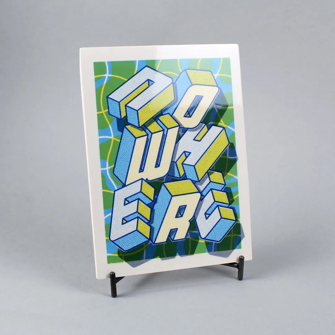 Screen-printed tile with an Artwork with the word NOWHERE from Halfstudio, with blue, yellow and green colors, against a gray background